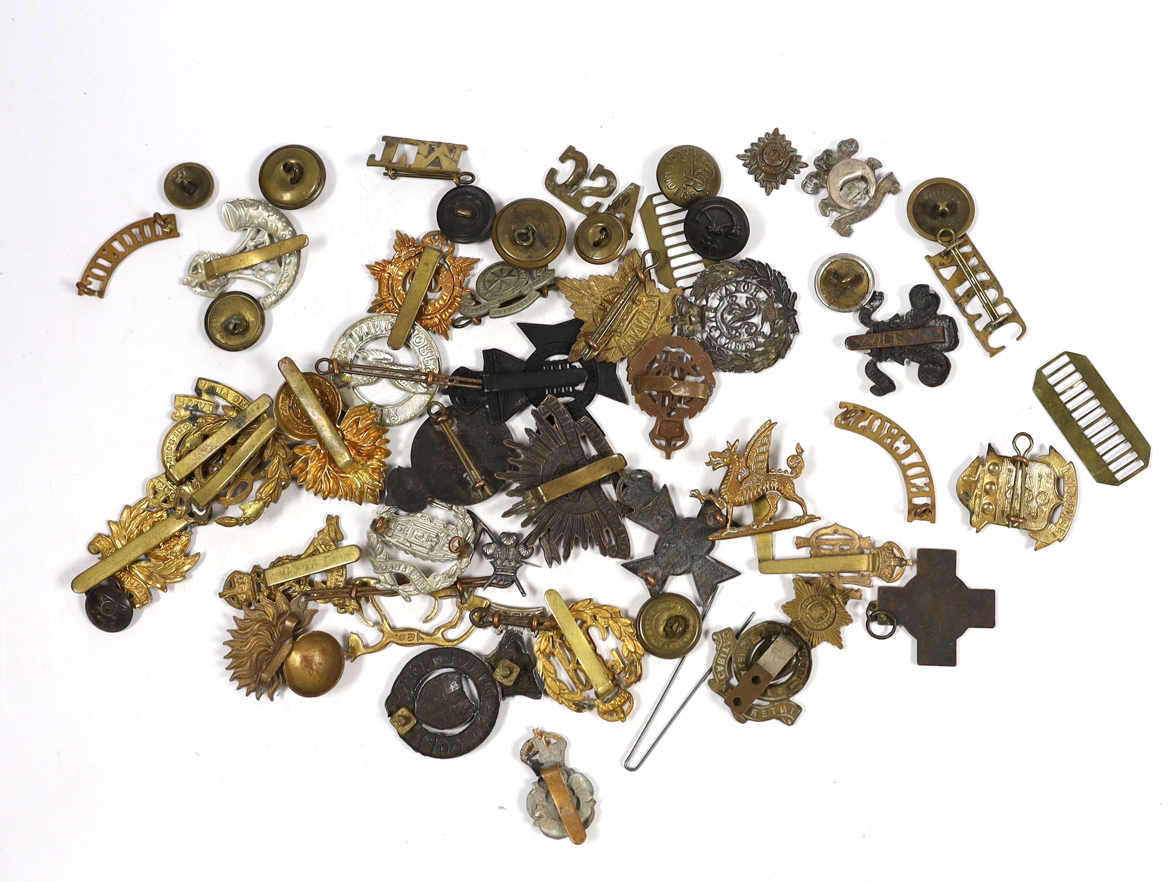 Twenty-five military cap badges including Air Training Corps, Australian Commonwealth Military Forces, Royal Army Ordinance Corps, Royal Engineers, Intelligence Corps, Royal Army Service Corps, RFC, etc. Together with a